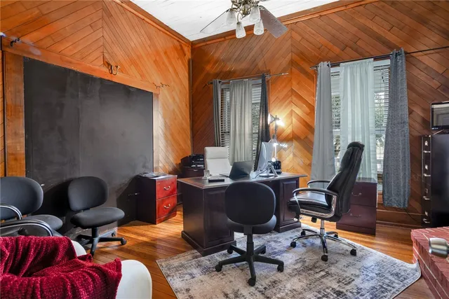 a livingroom with workspace and a couch