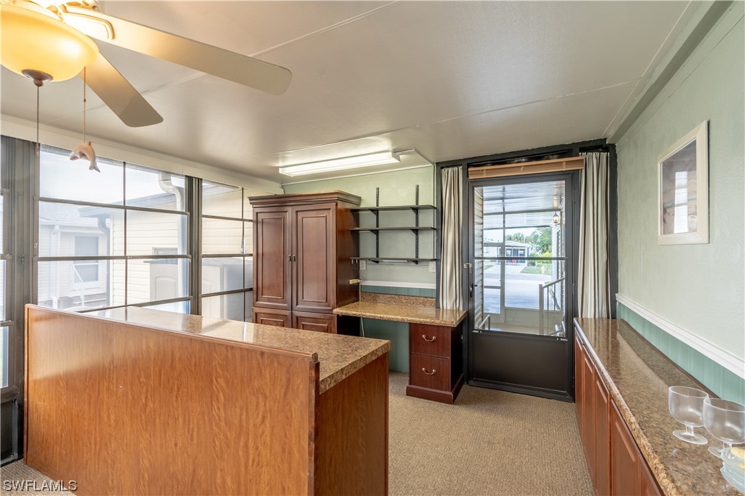 109 Audubon Road Naples, FL 34114 - Photo 14 of 41 a view of a kitchen with a sink and dishwasher with wooden floor