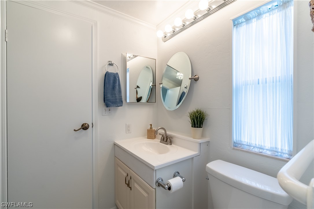 109 Audubon Road Naples, FL 34114 - Photo 16 of 41 a bathroom with a sink mirror and toilet