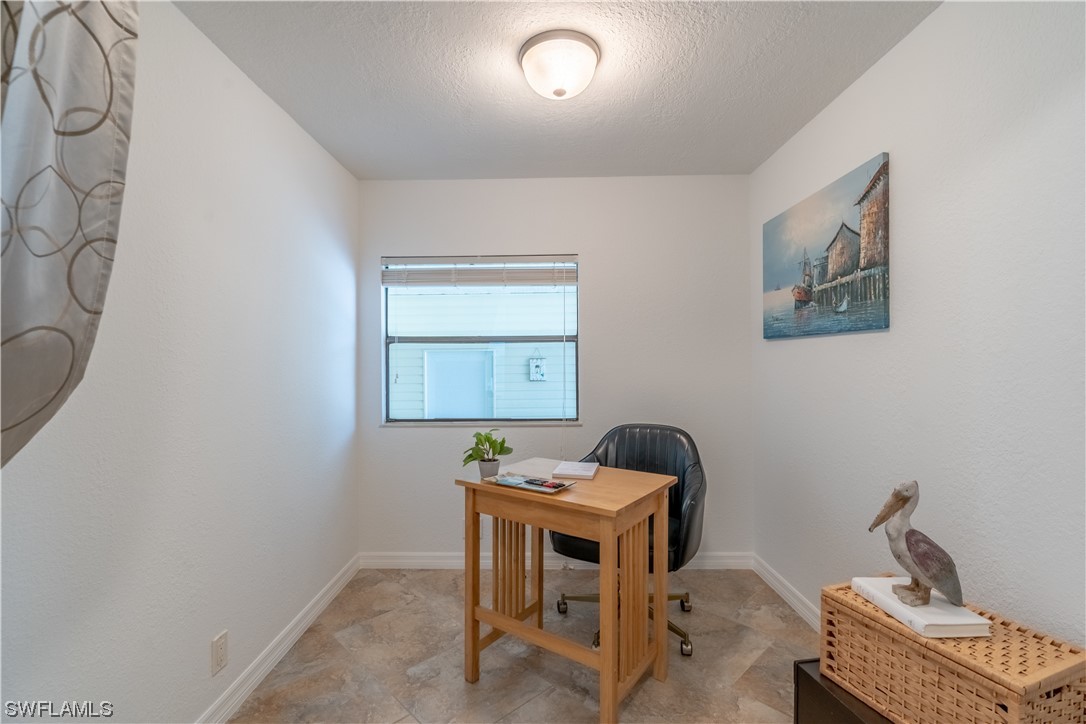 109 Audubon Road Naples, FL 34114 - Photo 17 of 41 a room with a table and chairs