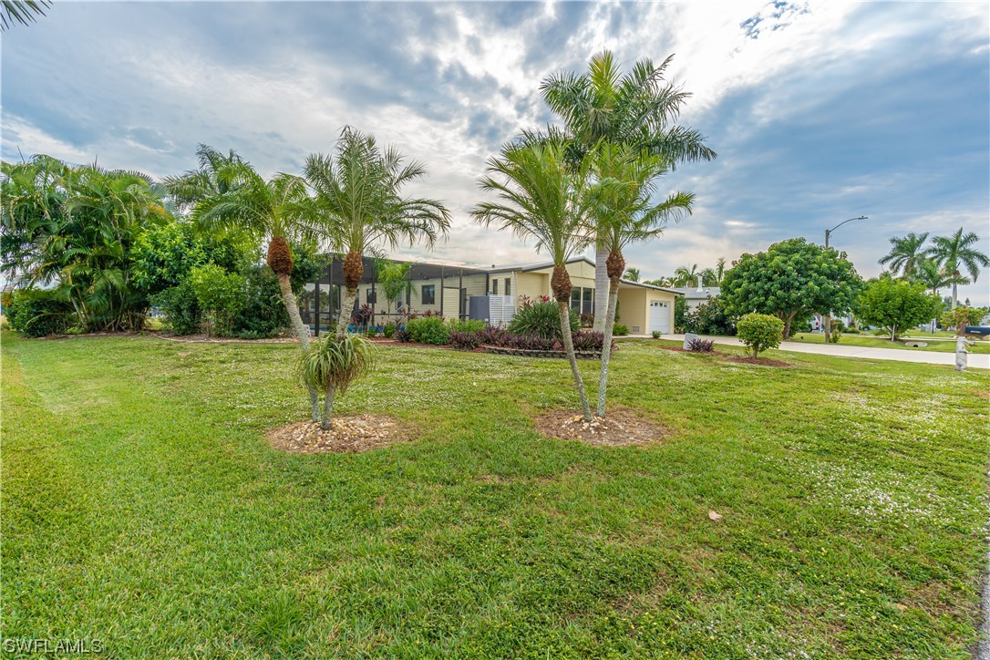 109 Audubon Road Naples, FL 34114 - Photo 2 of 41 a view of a house with a tree in a park
