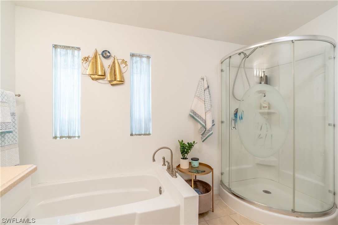 109 Audubon Road Naples, FL 34114 - Photo 25 of 41 a bathroom with a bathtub and a shower
