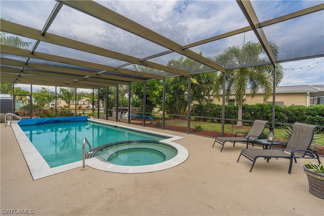 109 Audubon Road Naples, FL 34114 - Photo 26 of 41 a view of a swimming pool with a patio