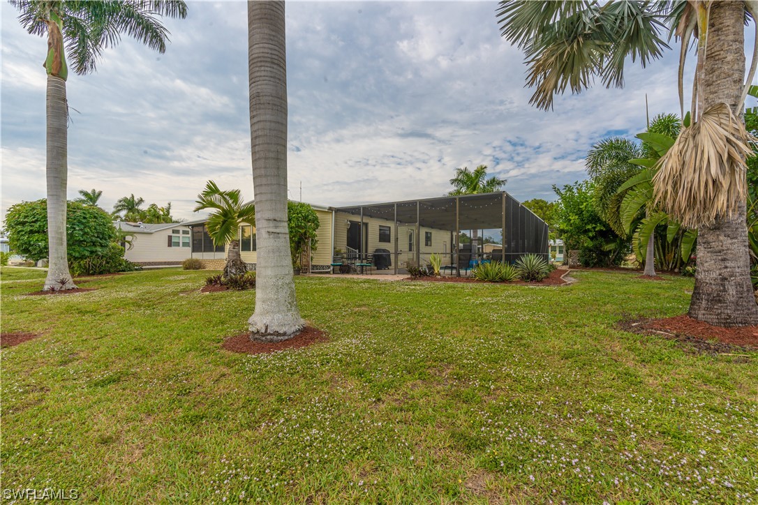 109 Audubon Road Naples, FL 34114 - Photo 28 of 41 a front view of multiple houses with yard