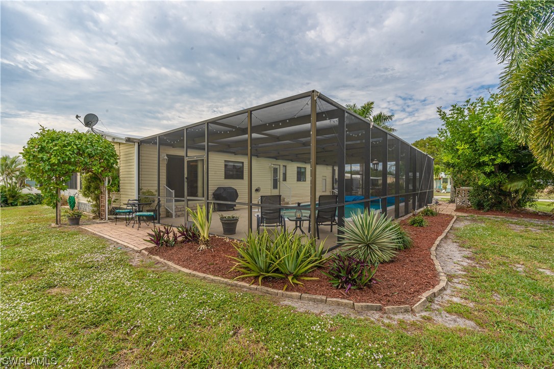 109 Audubon Road Naples, FL 34114 - Photo 29 of 41 a view of a house with backyard and sitting area