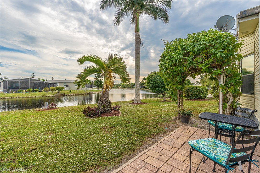 109 Audubon Road Naples, FL 34114 - Photo 32 of 41 a swimming pool with barbeque oven table and chairs