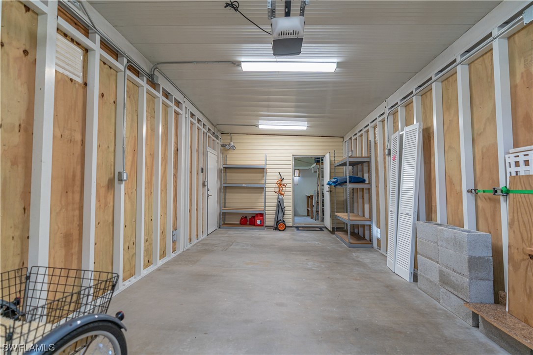 109 Audubon Road Naples, FL 34114 - Photo 35 of 41 a view of a hallway with wooden walls and windows