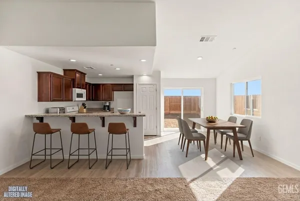 a dining room with furniture and wooden floor