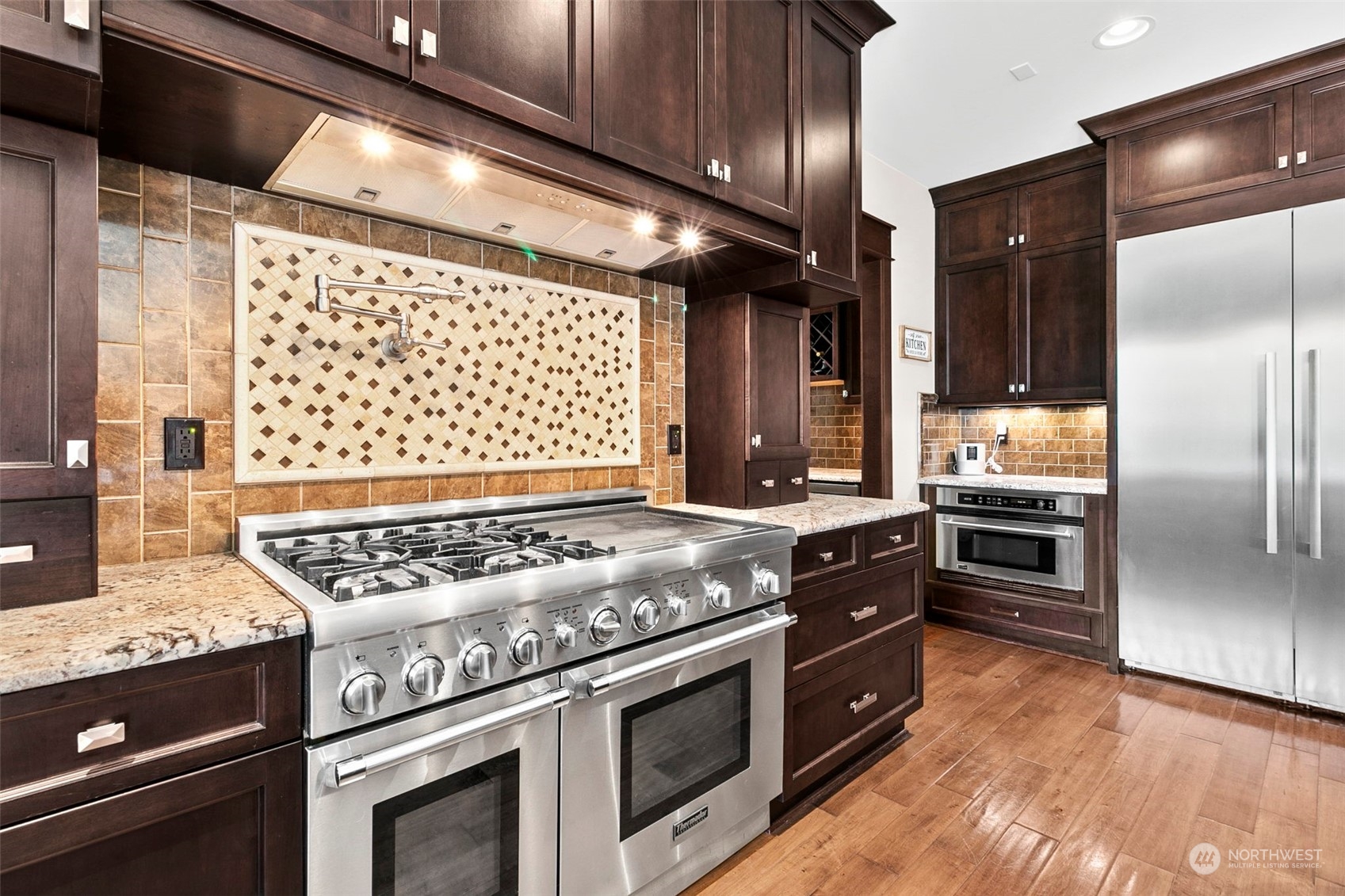 5308 Northeast 26th Street Renton, WA 98059 - Photo 12 of 40 a kitchen with granite countertop stainless steel appliances a stove and a refrigerator