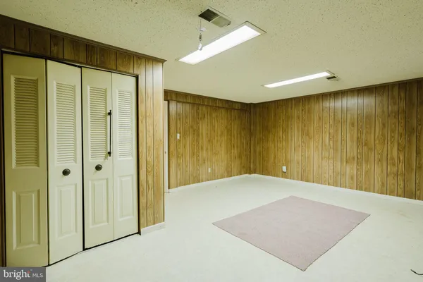 a view of a hallway with wooden shelves