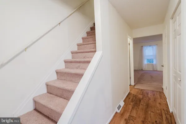 a view of entryway and hall with wooden floor