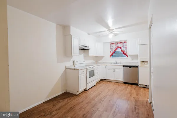 a kitchen with a white cabinets and white appliances