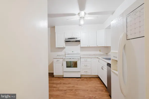 a kitchen with cabinets stainless steel appliances and a counter space
