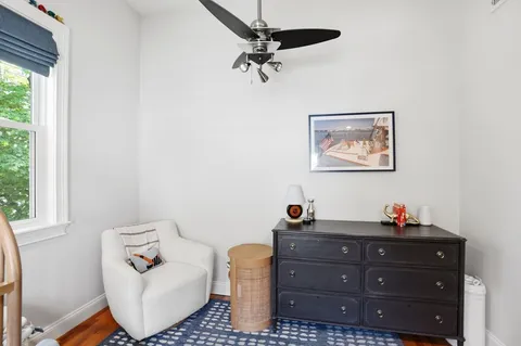 a living room with furniture a window and a chandelier