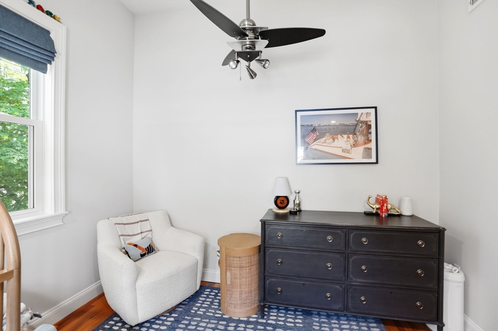 59 Elm Street Hingham, MA 02043 - Photo 23 of 33 a room with a baby bed a couch and a window