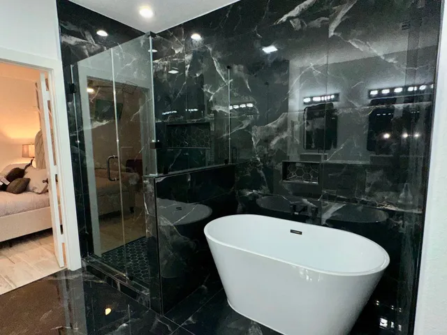 a bathroom with a bathtub and shower