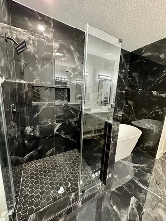 a bathroom with a glass shower door