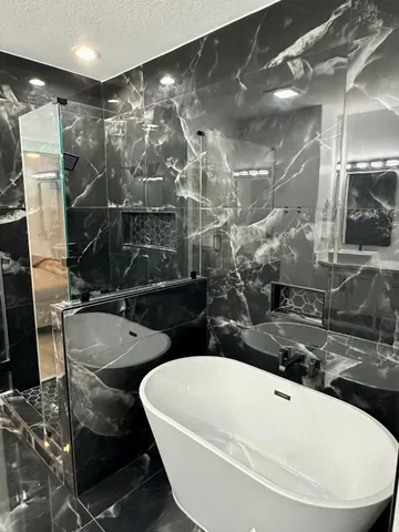 a bathroom with a tub sink and mirror
