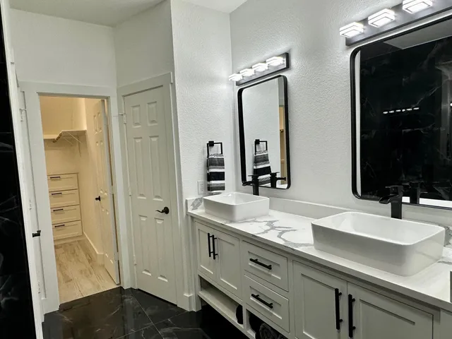 a bathroom with a double vanity sink and a mirror