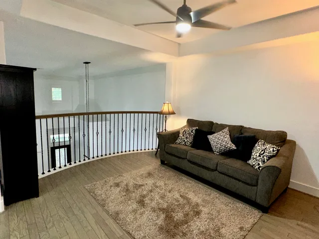 a living room with furniture and a chandelier