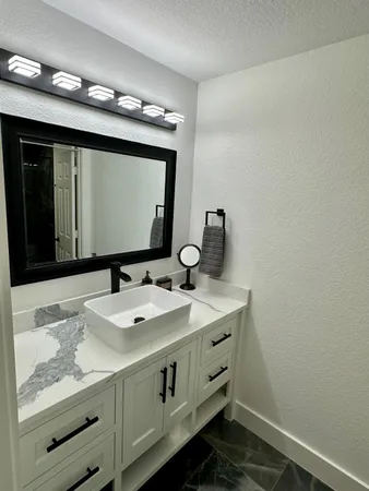 a bathroom with a sink and a mirror
