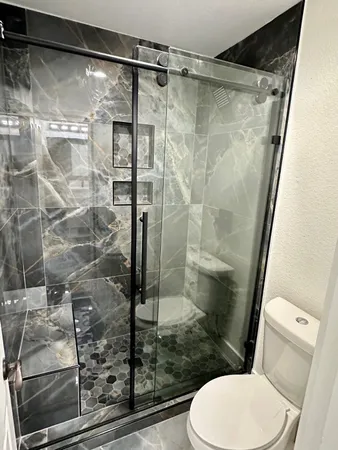 a bathroom with a shower and toilet
