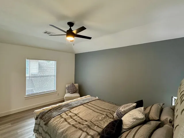 a bedroom with a bed and window