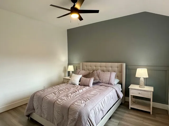 a bedroom with a bed and a night stand