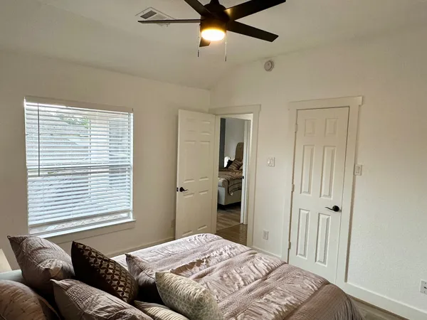 a bedroom with a bed and a window