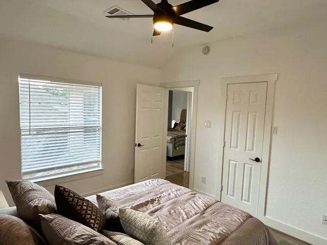 a bedroom with a bed and a window