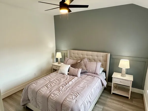 a bedroom with a bed and a lamp