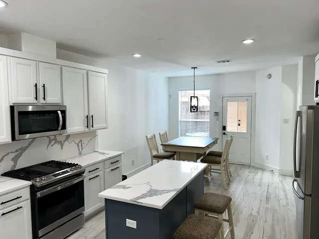 a kitchen with a stove a sink and a refrigerator