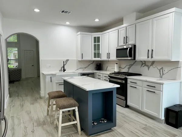 a kitchen with a sink cabinets and wooden floor