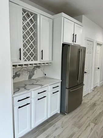 a kitchen with a refrigerator and a sink