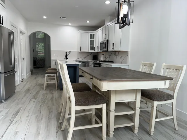 a kitchen with a table and chairs in it