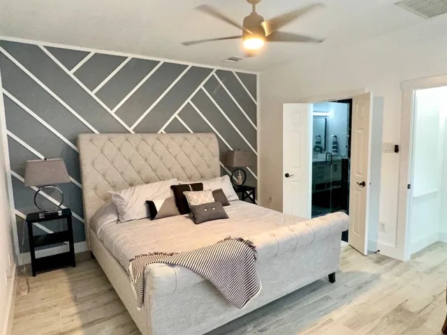 a bedroom with a bed and a ceiling fan