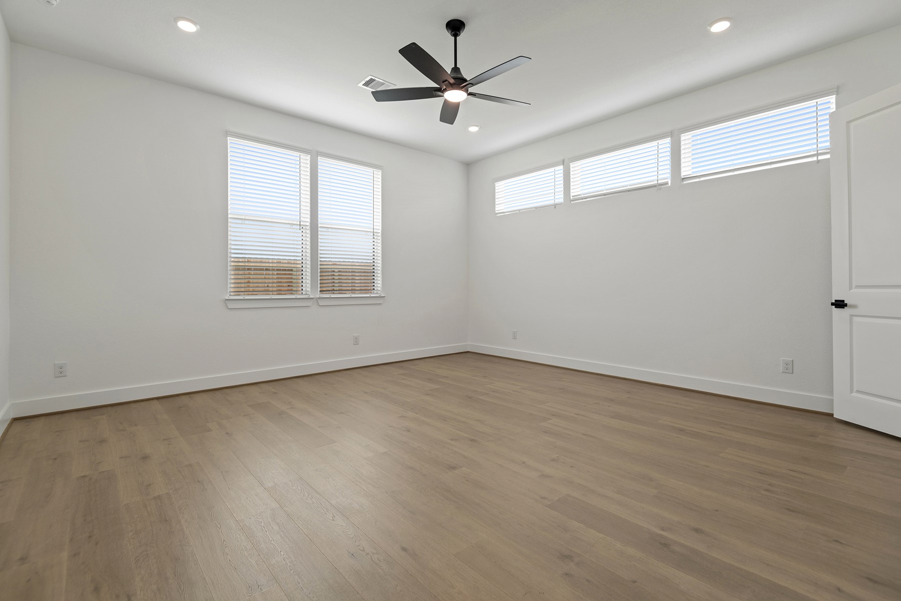 1911 Drover Lane Rosenberg, TX 77471 - Photo 16 of 22 an empty room with a window and a ceiling fan