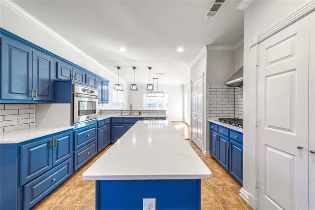 a large kitchen with wooden floors and wooden cabinets