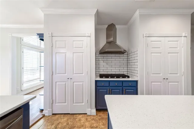 a kitchen with a refrigerator and a stove top oven