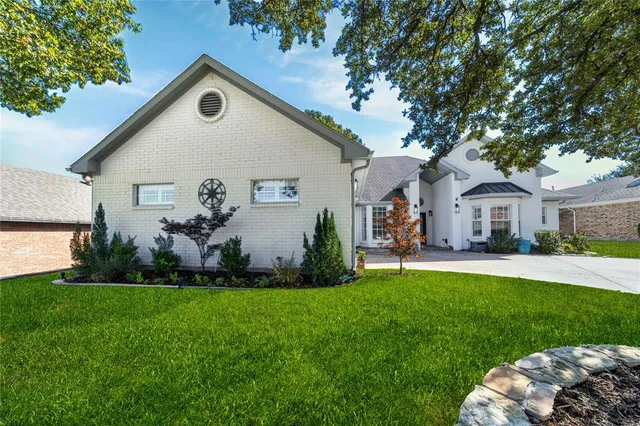 a front view of house with a garden and patio