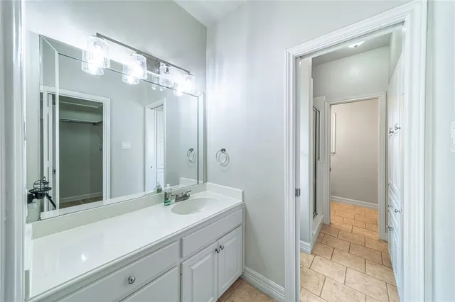 a bathroom with a sink a shower and a mirror