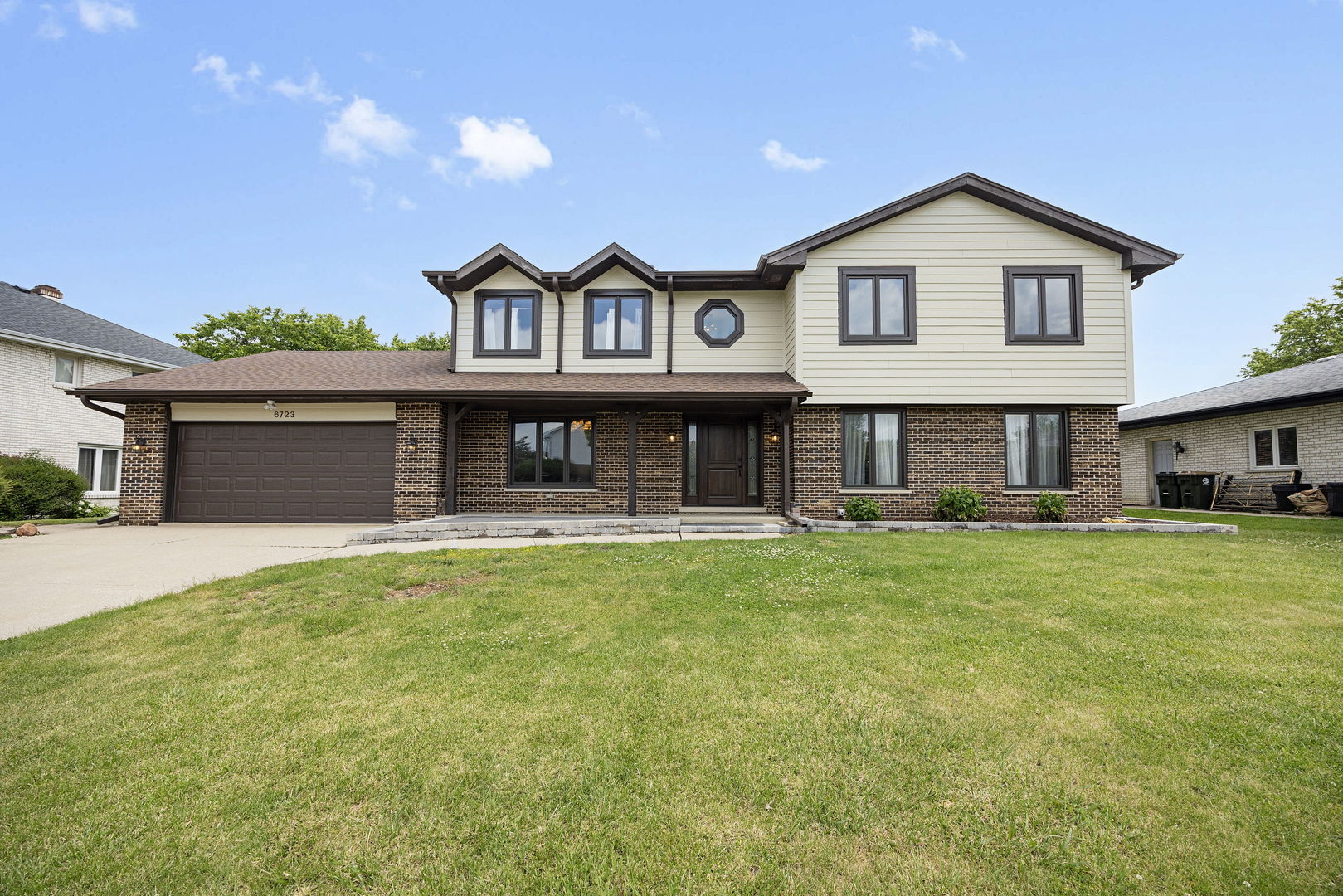 6723 Kingswood Road Willowbrook, IL 60527 - Photo 1 of 51 a front view of a house with a garden and porch