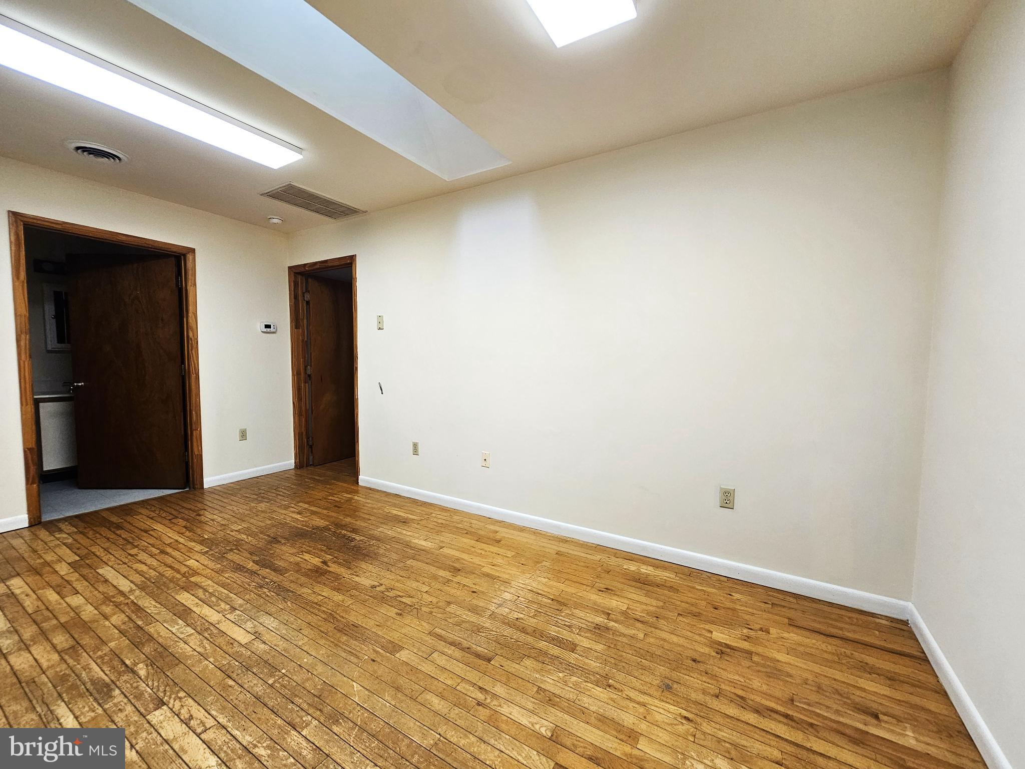809 Hanson Street, Unit A Salisbury, MD 21801 - Photo 11 of 11 Spacious room with warm wooden floors.
