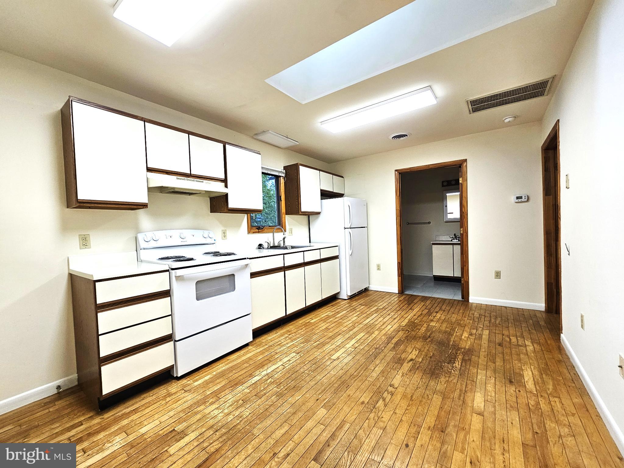 809 Hanson Street, Unit A Salisbury, MD 21801 - Photo 2 of 11 Spacious kitchen with warm wooden floors.