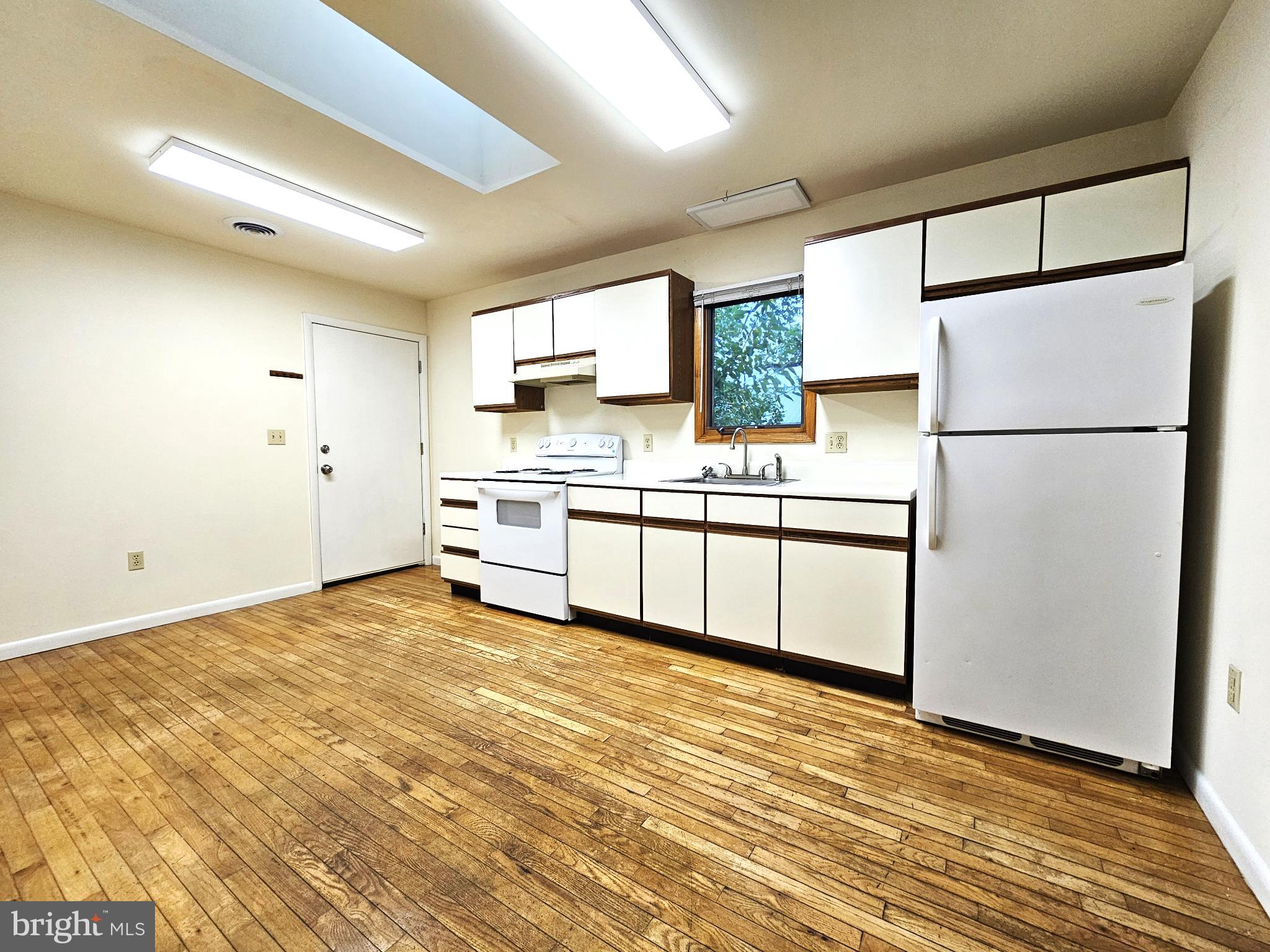 809 Hanson Street, Unit A Salisbury, MD 21801 - Photo 3 of 11 Bright and spacious kitchen with wooden floors.