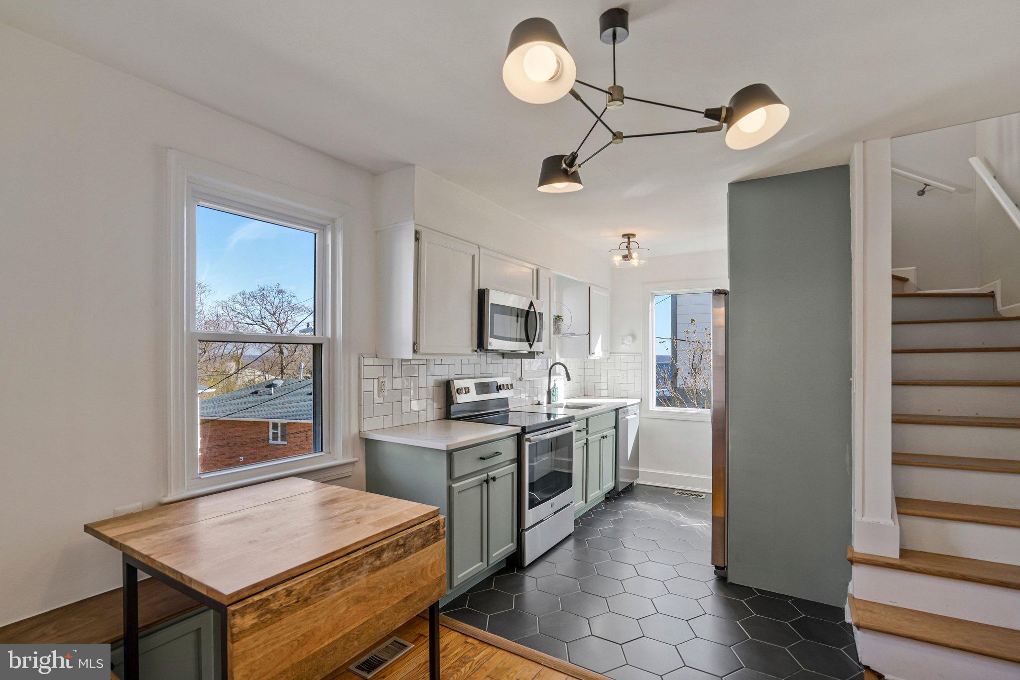 4140 21st Road North Arlington, VA 22207 - Photo 13 of 30 a open kitchen with stainless steel appliances granite countertop a stove refrigerator and cabinets