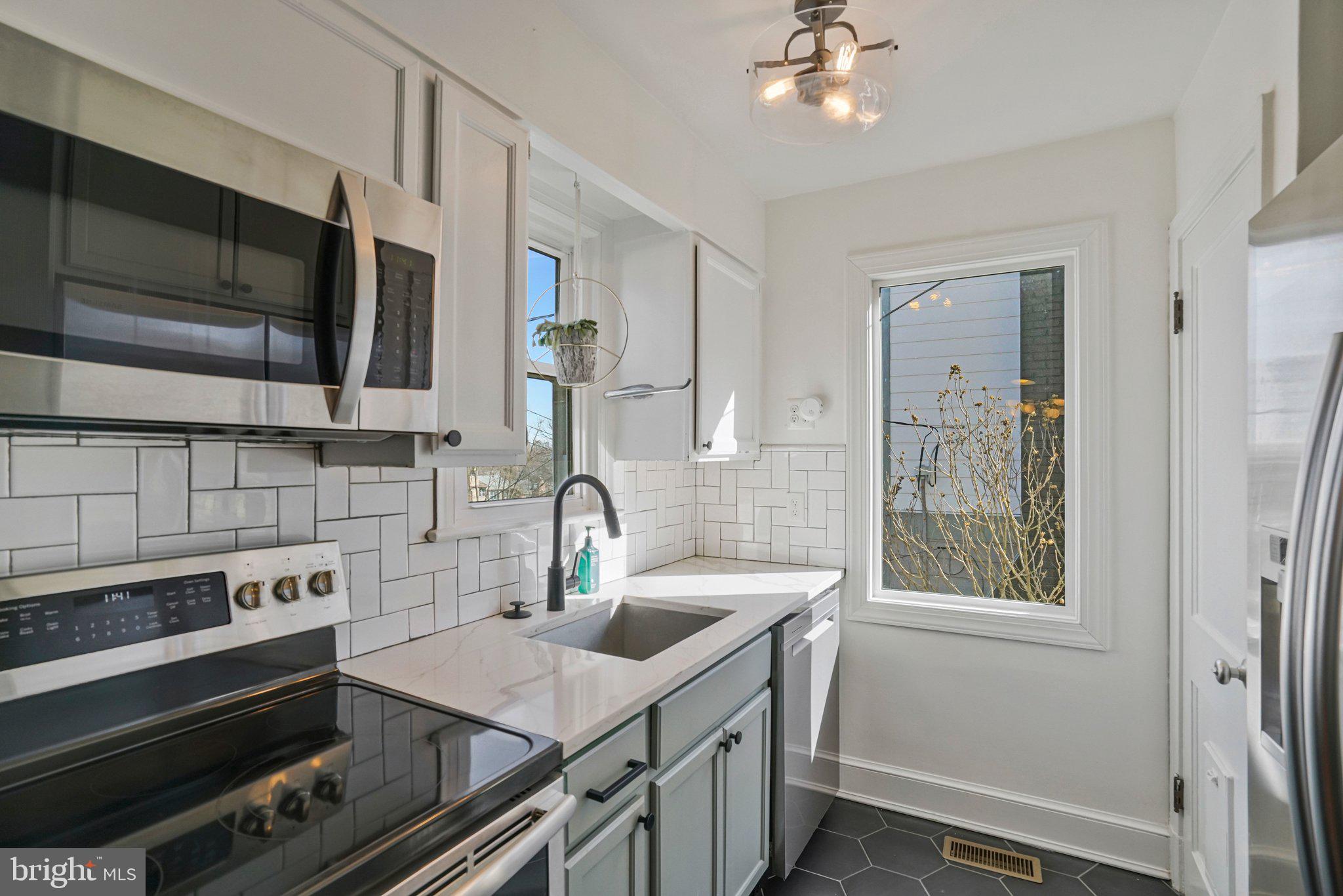 4140 21st Road North Arlington, VA 22207 - Photo 14 of 30 a kitchen with a sink stove and microwave