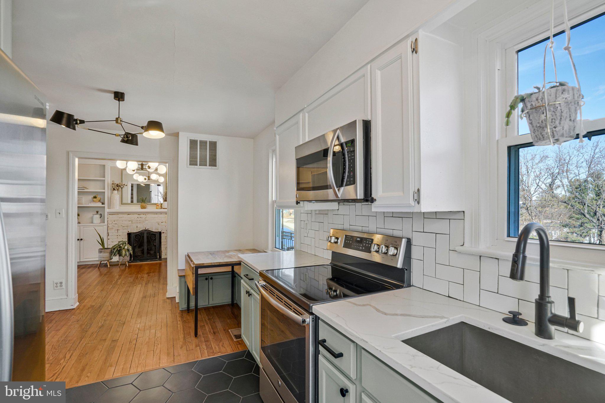 4140 21st Road North Arlington, VA 22207 - Photo 15 of 30 a kitchen with a sink and a stove top oven with wooden floor