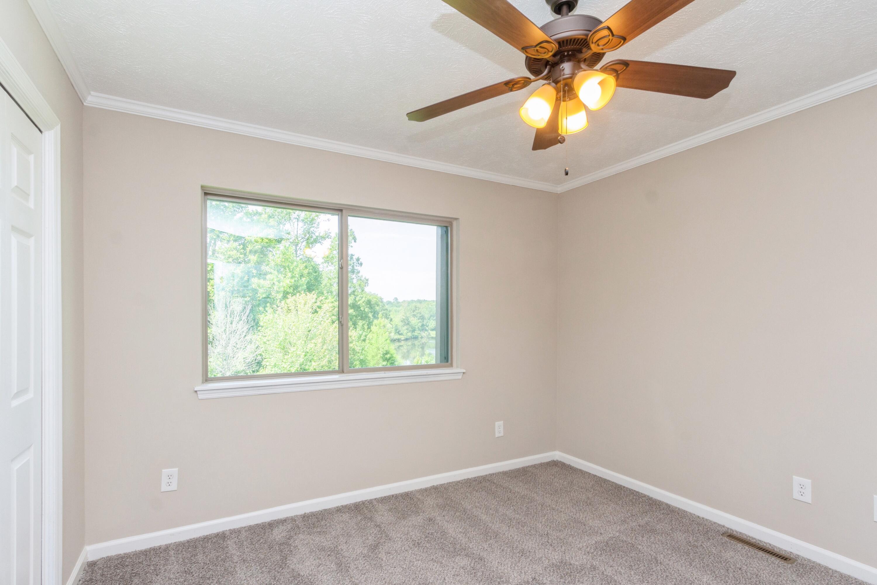 198 Hunters Run Edgefield, SC 29824 - Photo 24 of 31 an empty room with a window and a fan