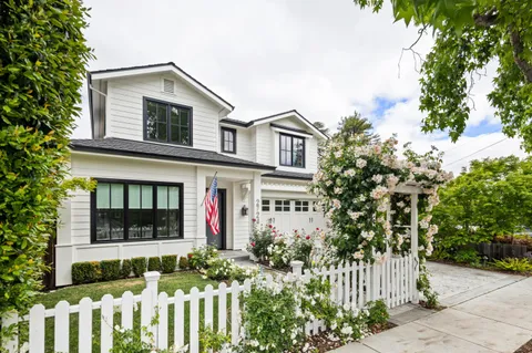 a front view of a house with a garden